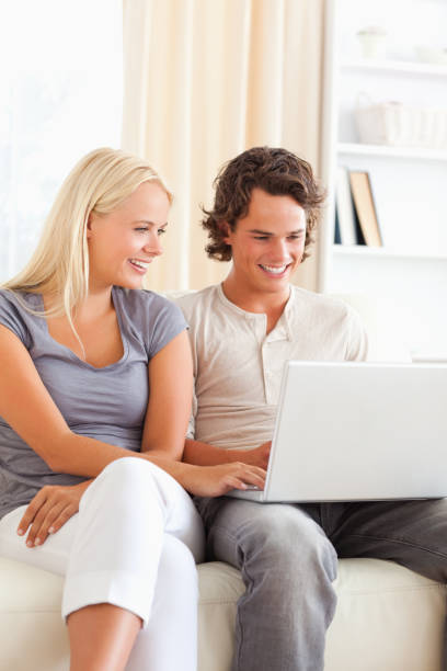 istock Portrait of a cute happy couple using a notebook 855420616