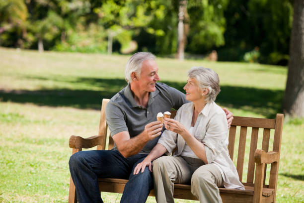 istock Senior couple eating an ice cream on a bench 855421122