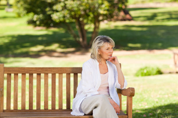 istock Senior woman thinking on the bench 855421606