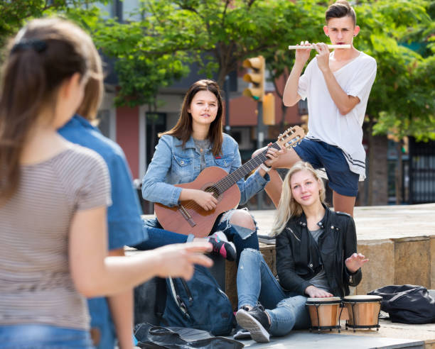 istock Friends musicians with instruments in park 855422100