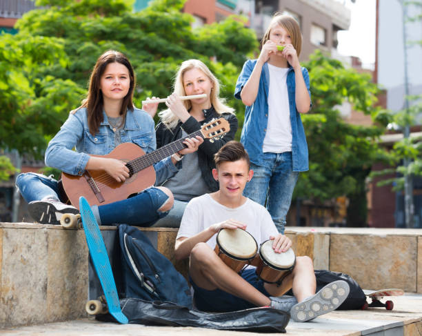 istock Happy four friends with musical instruments 855422160