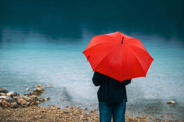 istock Woman with red umbrella 855424276