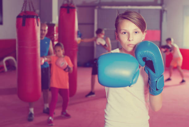 istock Boxer in gloves posing during boxing exercising 855429760
