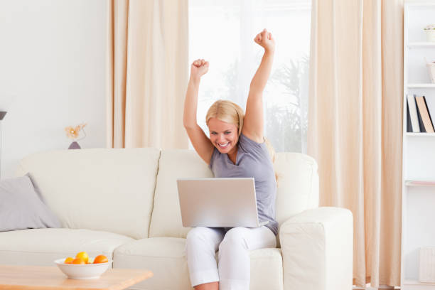 istock Cheerful blonde woman using a laptop 855430134