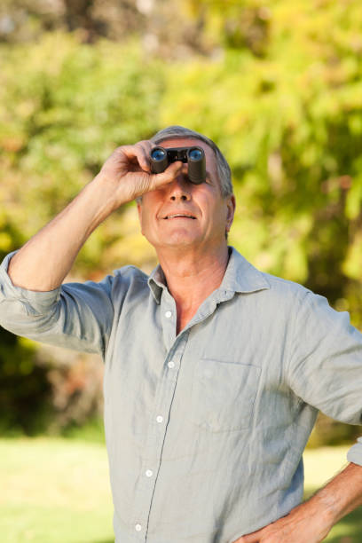 istock Elderly man looking at the sky with his binoculars 855432678