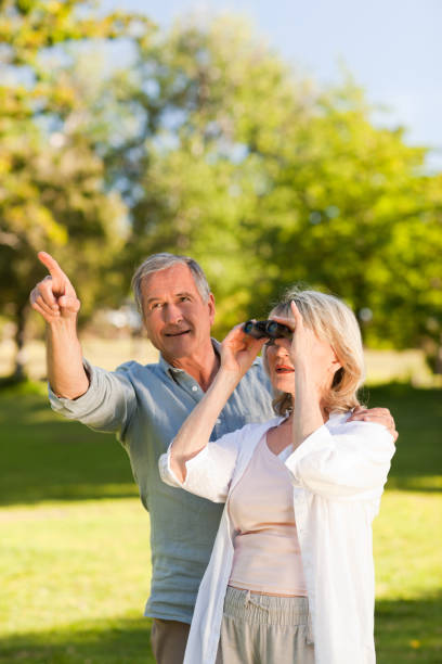 istock Couple looking at the sky with their binoculars 855433188