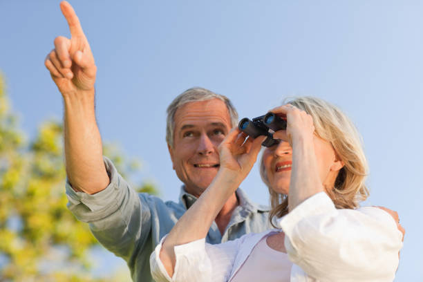 istock Couple looking at the sky with their binoculars 855433204