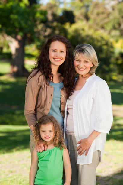 istock Smiling family looking at the camera in the park 855433882
