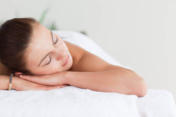 istock Close up of a cute brunette lying on a massage table 855433886