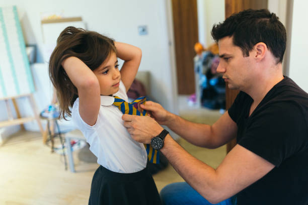 istock Father is preparing girl for school 855438858