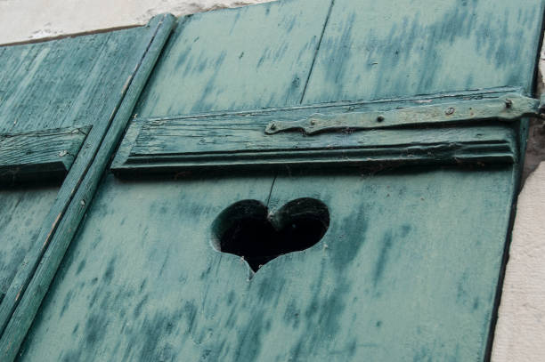 closeup of shaped heart in wooden shutters