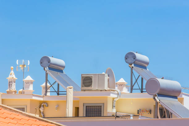 Solar panels and boilers on roof of building stock photo