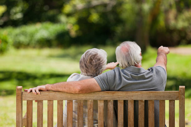 istock Couple sitting on the bench with their back to the camera 855440106