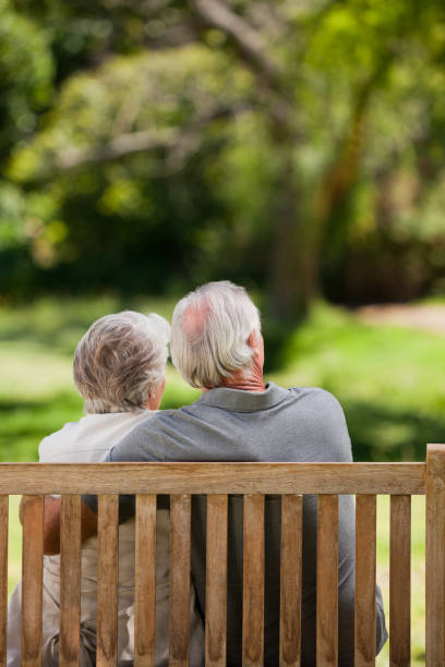 istock Couple sitting on the bench with their back to the camera 855440156