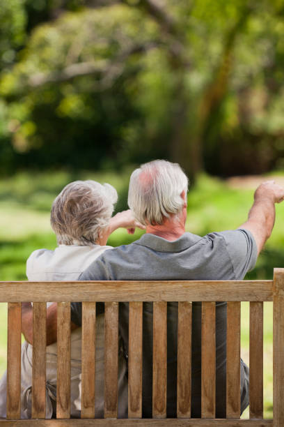 istock Couple sitting on the bench with their back to the camera 855440226