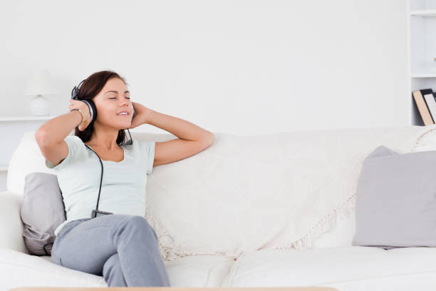 istock Good looking brunette listening to music 855443444