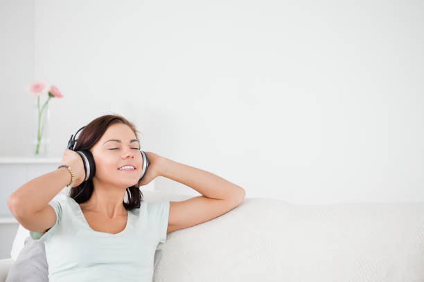 istock Delighted brunette listening to music 855443616