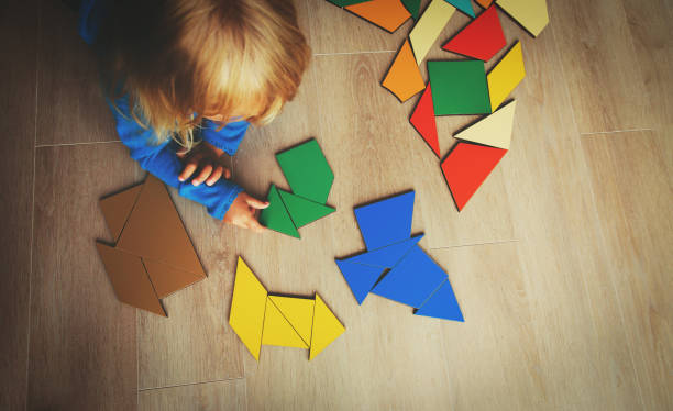 istock little girl playing with puzzle 855444158