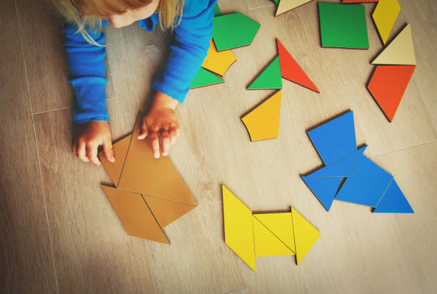 istock little girl playing with puzzle 855444390