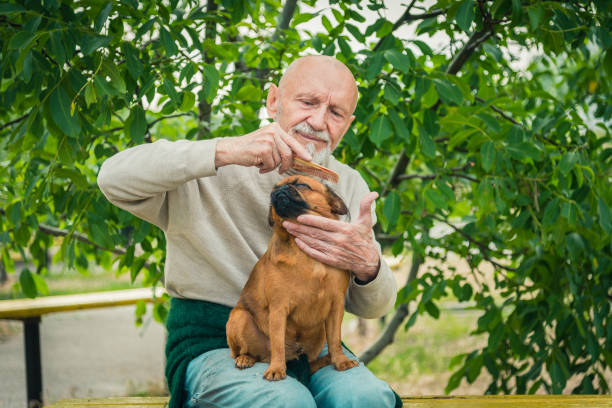 istock Grandfather with a dog of the Griffon breed 855446992