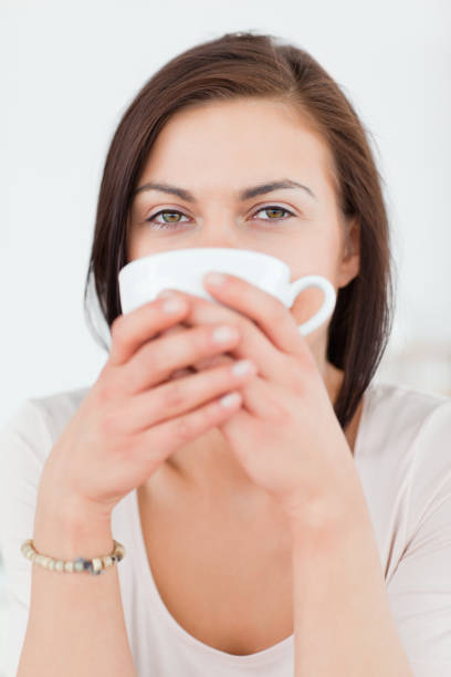 istock Smiling darkhaired woman having a tea 855448058