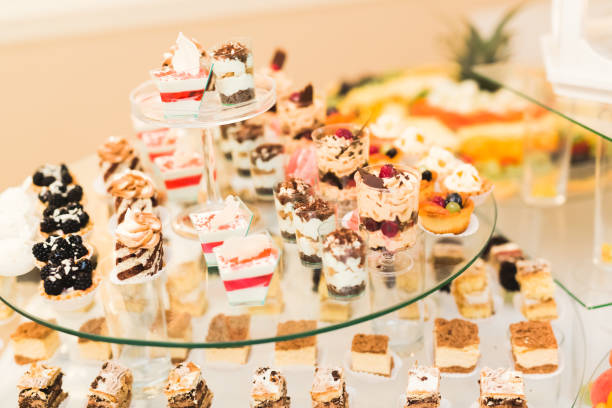 istock Delicious and tasty dessert table with cupcakes shots at reception closeup 855450206