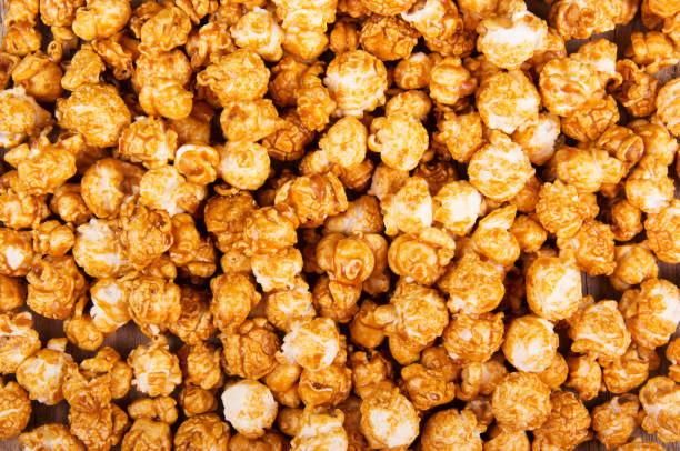 Golden caramel popcorn closeup. Background of popcorn. Snacks and food for a movie stock photo