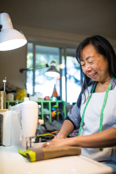 istock A mature woman working with a sewing machine in a small art studio 855450658