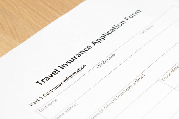 istock Travel insurance application form wait to fill information on desk background 855450684