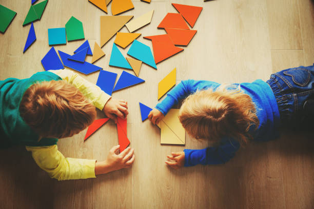 istock kids playing with puzzle, education concept 855451288