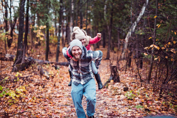 istock Daughter with dad walking in the autumn forest 855451508
