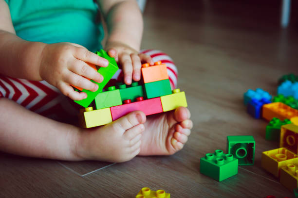 istock little baby playing with colorful plastic blocks 855451586