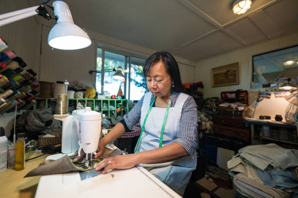 istock A mature woman working with a sewing machine in a small art studio 855455480