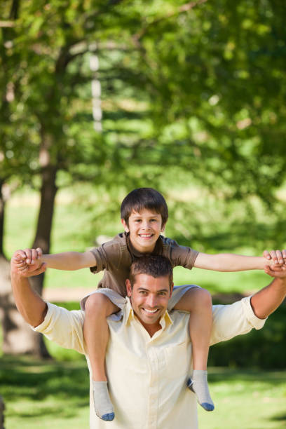 istock Handsome man giving son a piggyback 855458396