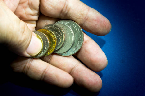 istock Many Thailand coins in male hand. 855458908