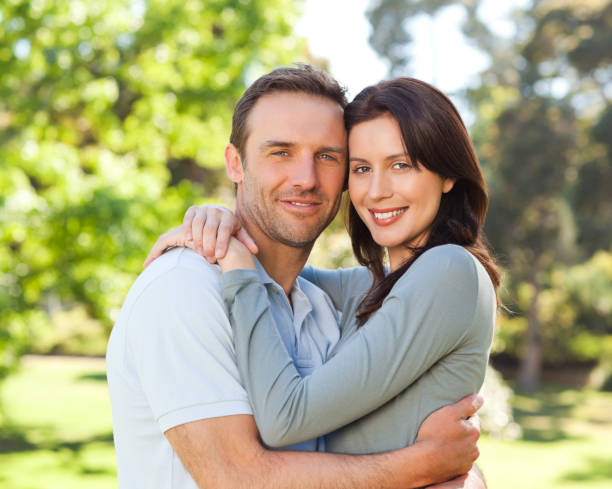istock Radiant couple hugging in the park 855464388