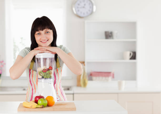 istock Attractive brunette woman posing with a mixer while standing 855467216