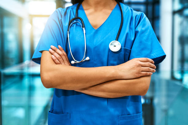 These hands will take care of you Shot of an unrecognisable nurse standing in a hospital medical scrubs stock pictures, royalty-free photos & images