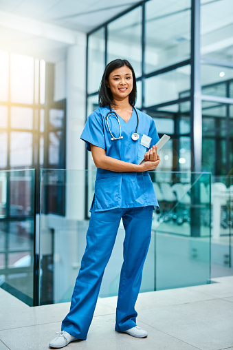 Portrait of a young nurse standing in a hospital