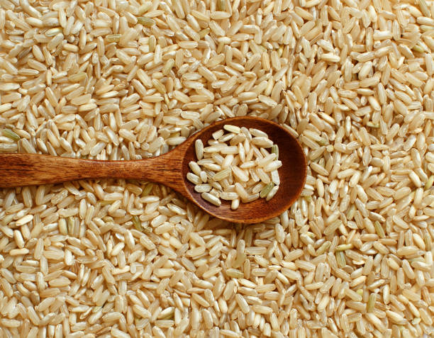 istock Pile of Brown rice with a spoon 855467616