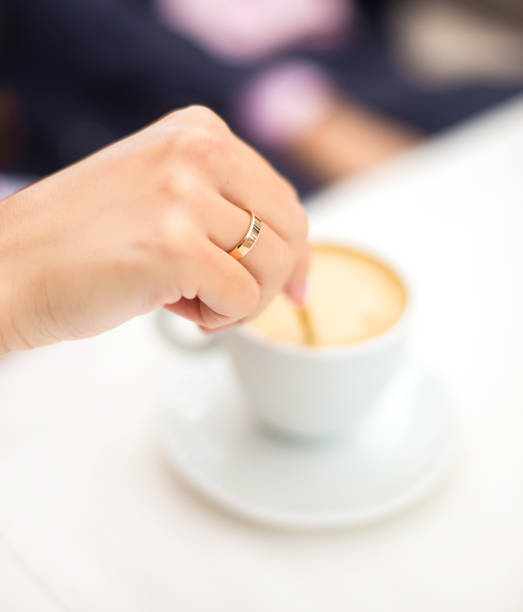 istock woman hand stir coffee in cafe 855470822