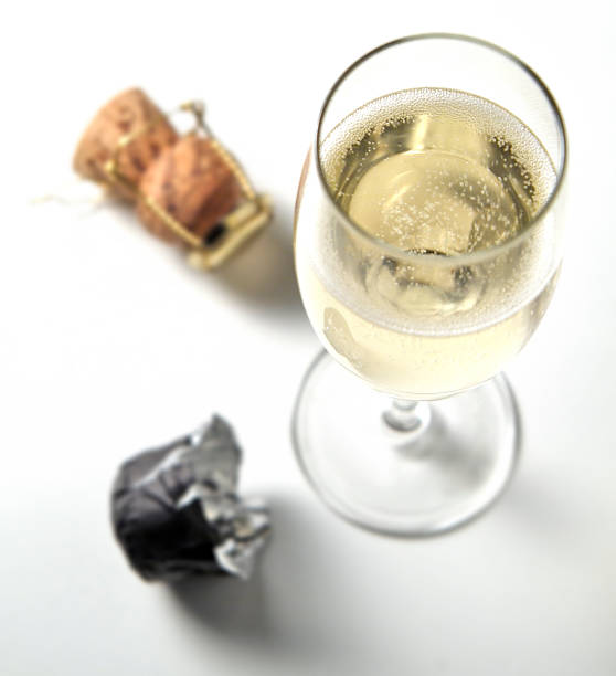 Top view of sparkling glass flute and caps
