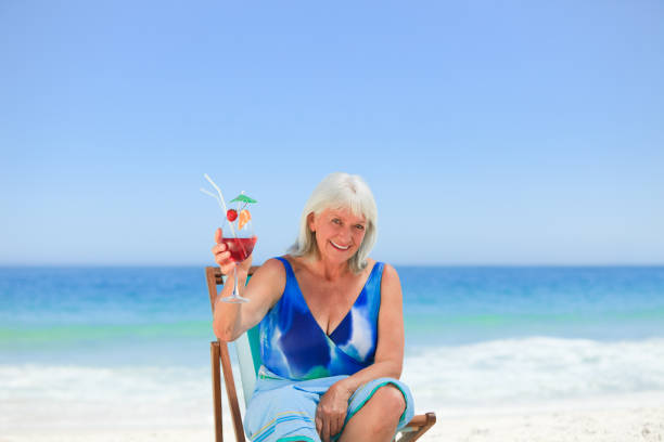 istock Elderly woman drinking a cocktail 855471794