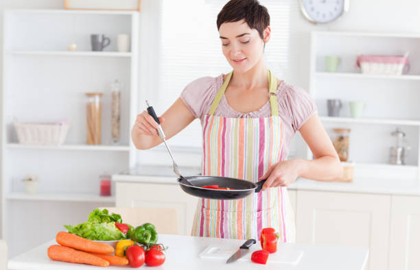 istock Cute woman cooking 855475486