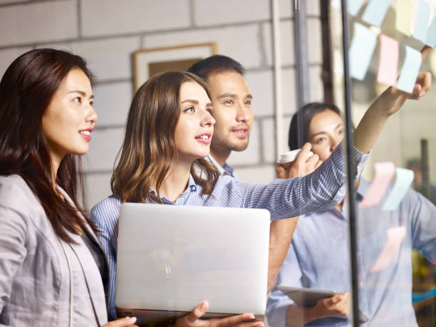 asian and caucasian business team working in office
