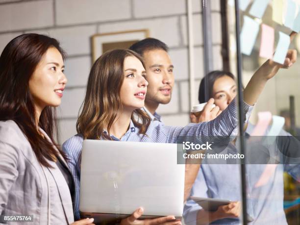 Asian And Caucasian Business Team Working In Office Stock Photo - Download Image Now