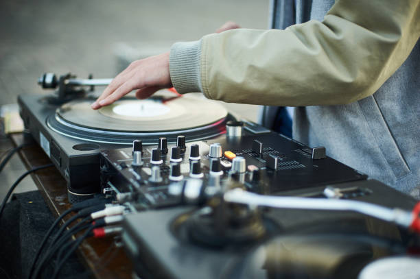 istock turntable, hand of dj on the vinyl record 855478846