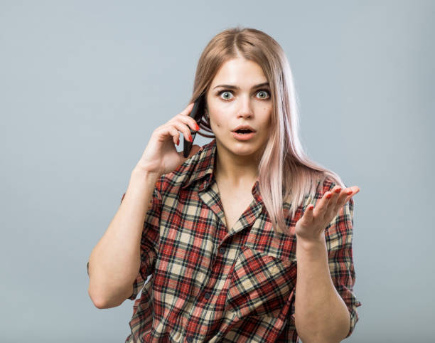 istock Cute young woman using smartphone 855479256