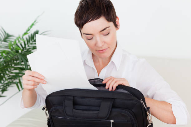 istock Businesswoman putting some papers in her bag 855483868