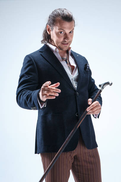 istock The mature barded man in a suit holding cane 855484560